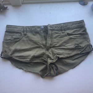 Army green ripped jean shorts
